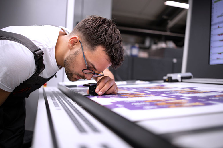Employee inspecting printing quality